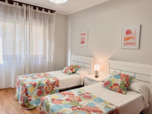 Postel nebo postele na pokoji v ubytování Apartamento Playa Panadeira Sanxenxo