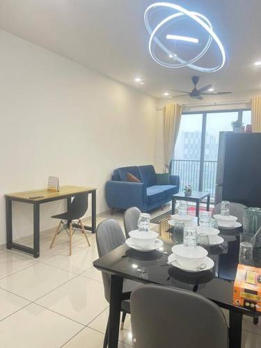 a living room with a table and a blue couch at Cozy Kenwingston Platz KL 2-5 Pax2BR&2BR Pakin Netflix 1306 in Kuala Lumpur