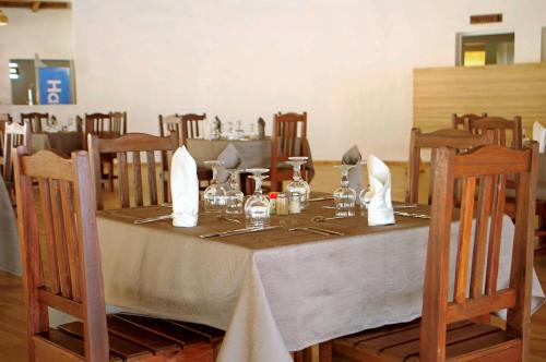 a table in a restaurant with a table cloth and chairs at King baobab lodge in Diakhanor