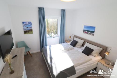 Katil atau katil-katil dalam bilik di 15 Ferienwohnung Inselschatz mit Wallbox