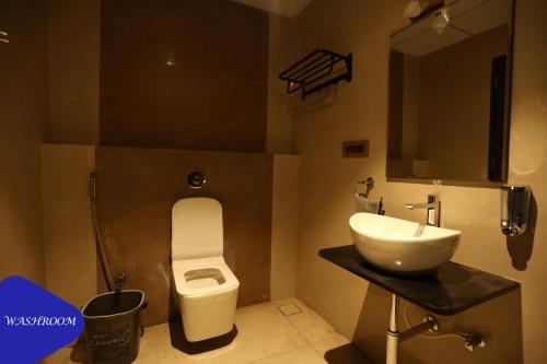 a bathroom with a sink and a toilet at Royal Twin Lonavla - 12BHK Luxury Villa with Turf in Lonavala