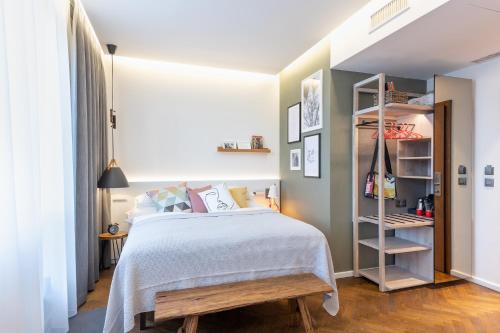 a bedroom with a bed and a book shelf at MOSAIC HOUSE Design Hotel in Prague