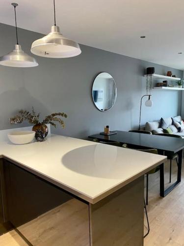 a kitchen with a large white counter in a room at Luxury apartment close to Theatre, Barbican & Hoe 2 kings or 4 single beds secure covered parking in Plymouth