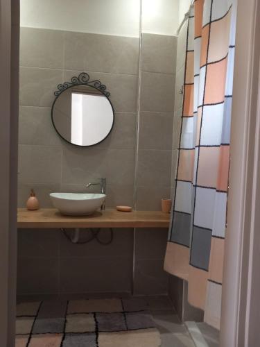 a bathroom with a sink and a mirror at loft in Pýrgos