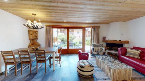 a living room with a table and a red couch at Apartment Ambretta EG in Champfer