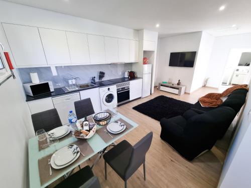 a kitchen and living room with a table and a couch at Casa Caromba, Sunset in Prazeres