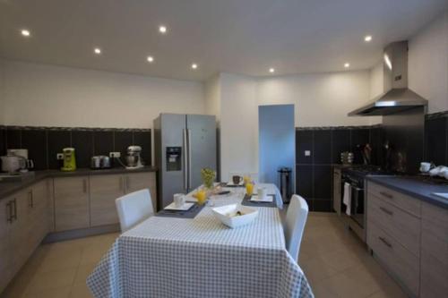 a kitchen with a table and chairs in a kitchen at Maison jasmin Porto Vecchio in Porto-Vecchio