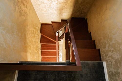 a spiral staircase in a building with wooden steps at Casa Korman in Giarmata