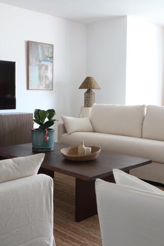 a living room with a white couch and a coffee table at Heart of Funchal 4 BD Apartment - Casa d Alma in Funchal