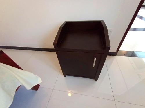 a black box sitting on a white floor at Would Villa Mirissa in Mirissa