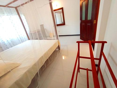 a bedroom with a bunk bed and a red stool at Would Villa Mirissa in Mirissa