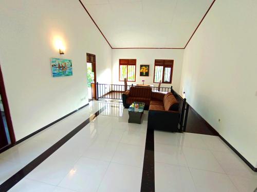 a living room with a couch and a table at Would Villa Mirissa in Mirissa