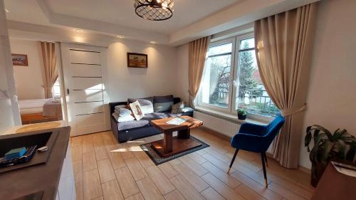 a living room with a couch and a table at Apartamenty Biała Perła in Ustroń
