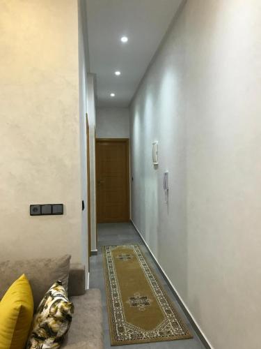 a hallway with a couch and a rug on the floor at AM Atlas Home in Ifrane