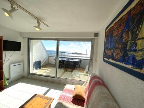 un salon avec un canapé et une vue sur l'océan dans l'établissement Appartement 2 pièces 4-5 personnes - vue imprenable sur la mer - MELWENN, à Ploemeur