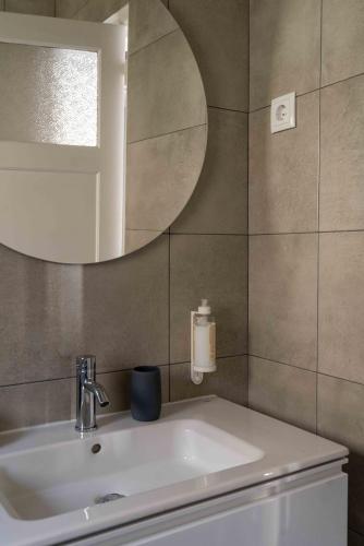 a bathroom with a sink and a mirror at Charm House Sintra 45 - Pena Garden Flat in Sintra