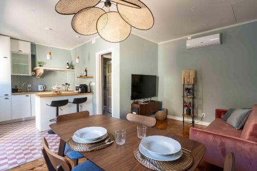 a living room with a dining table and a kitchen at Charm House Sintra 45 - Pena Garden Flat in Sintra