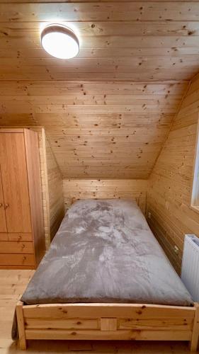 a small room with a bed in a wooden cabin at Wellness House Prague Pohádkový Ráj in Prague