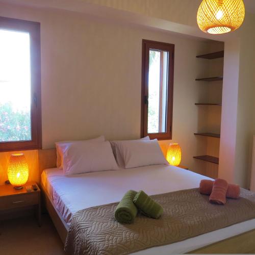 a bedroom with a bed with two pillows on it at Maleme ocean front serenity in Ayiá