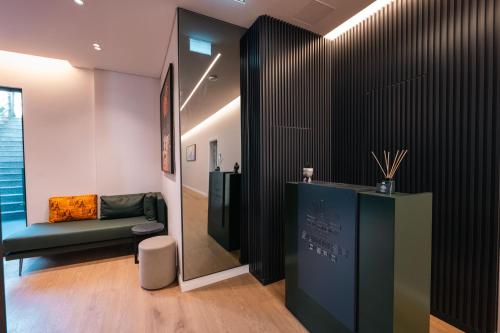 a room with a hallway with a couch and a window at Summer Depo in Sarandë