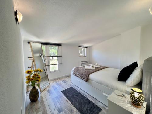 a bedroom with a large bed and a mirror at Albufeira Stylish 3 by Homing in Albufeira