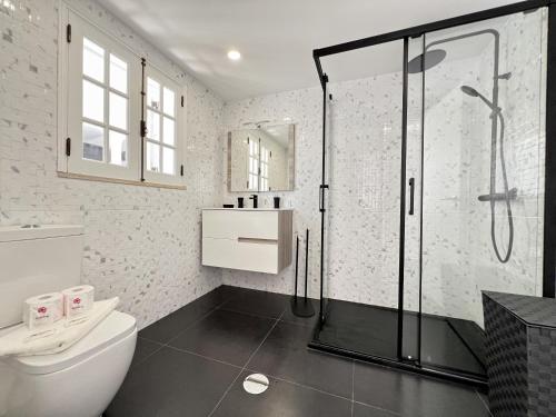 a bathroom with a glass shower and a toilet at Albufeira Stylish 3 by Homing in Albufeira
