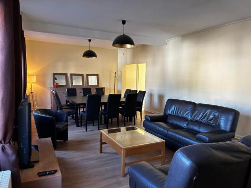 a living room with a couch and a table at Chambres privées in Jonchery-sur-Vesle