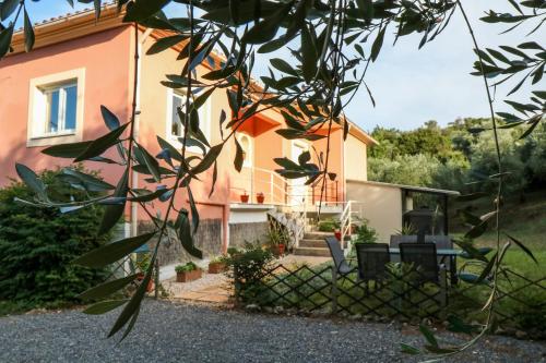 a view of a house from behind a tree at Villa Sunrise apartment in Gouvia
