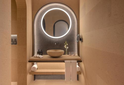 a bathroom with a sink and a mirror at The Chedi Hegra, AlUla in AlUla