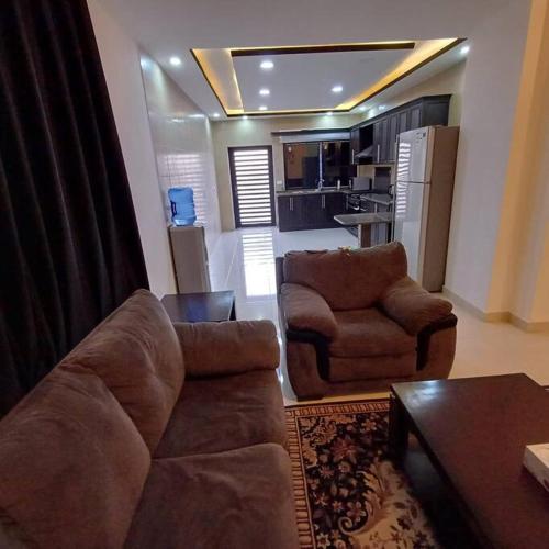 a living room with a couch and two chairs at Laperla luxury family apartment one in Amman
