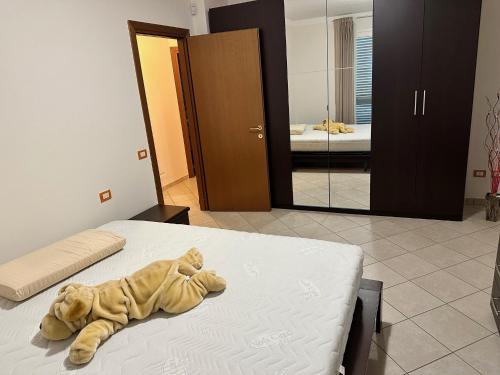 a stuffed animal laying on a bed in a room at STAFFOLI Home in Pianore