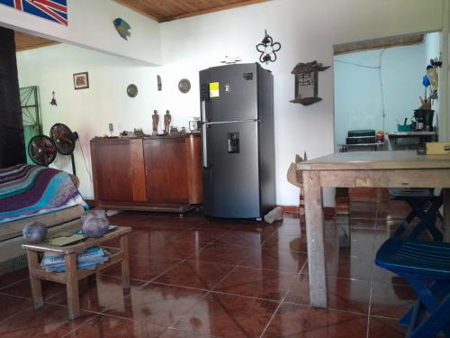 a kitchen with a refrigerator and a table in a room at Casa del Rio Low cost in Honda