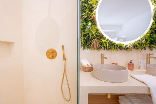a bathroom with a sink and a mirror at Hermès - Appartement avec jacuzzi scandinave in Nyons