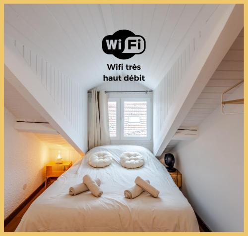 a bedroom with a bed with two pillows on it at Chez Noé I T2 I Thonon in Thonon-les-Bains