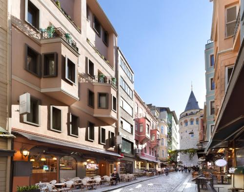 a city street with buildings and tables and chairs at Hotel Des Arts Galata in Istanbul