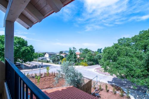 a view of a street from a balcony at חדרי אירוח בהט in Ein Zivan