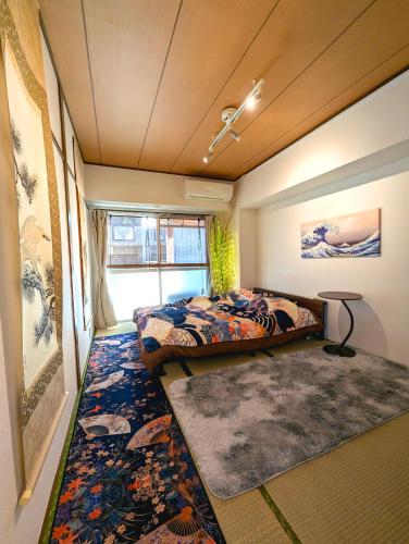 a bedroom with a bed and a rug at Asakusa Tokyo T'sRoom in Tokyo