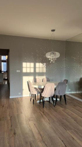 a dining room with a table and chairs at Diamond Apartment in Grudziądz