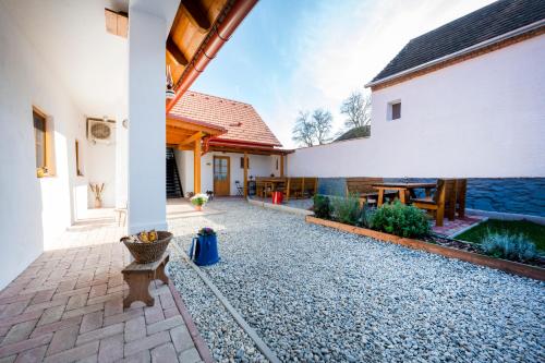 a courtyard of a house with a patio at Szépapám háza in Horvátzsidány