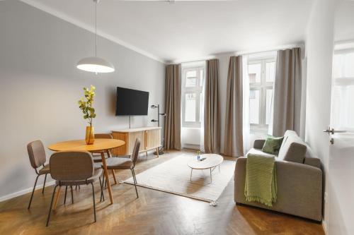 a living room with a couch and a table at Limehome Prague Halkova in Prague