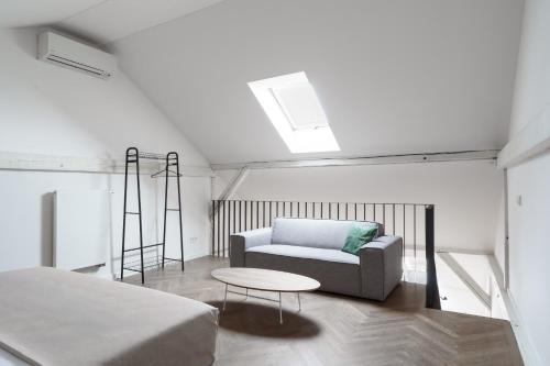 a living room with a couch and a table at Limehome Prague Halkova in Prague