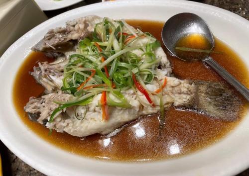 a white plate of food with soup and a spoon at KP Hotel Udonthani in Amphoe Kumphawapi