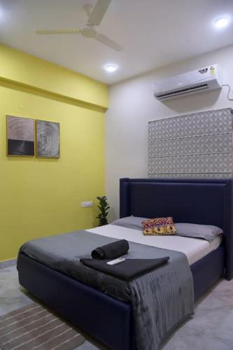 a bedroom with a bed in a room with a fan at Aavasam - 3BHK- Gachibowli in Hyderabad