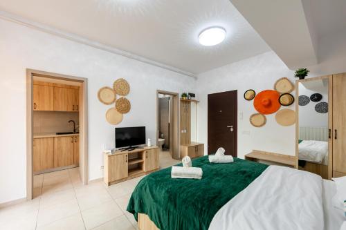 een slaapkamer met een groot bed en een televisie bij Matei Basarab Chic Studio in Boekarest