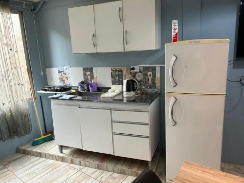 a kitchen with white cabinets and a refrigerator at "Edificio Don Luis" en Bajada Vieja in Posadas