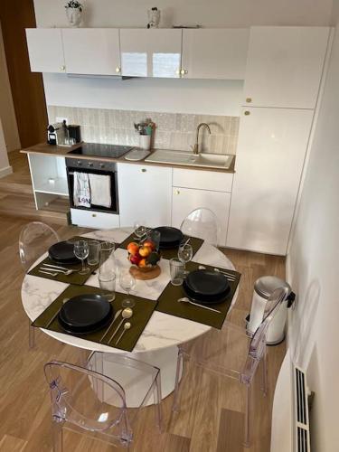 - une cuisine avec une table et une assiette de fruits dans l'établissement Appartement T3 - Face à la plage, à Saint-Jean-de-Luz