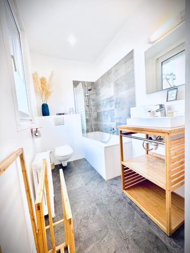 a bathroom with a sink and a toilet and a tub at Hôtel Jules in Le Touquet-Paris-Plage