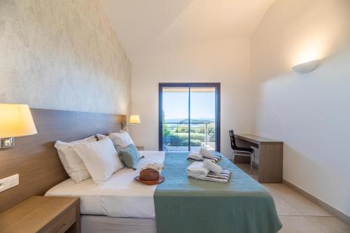 a bedroom with a bed with a table and a desk at Résidence Les Terrasses de Rondinara in Bonifacio