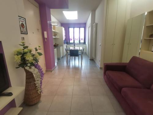 a living room with a couch and a table at Casa Violetta in Alba