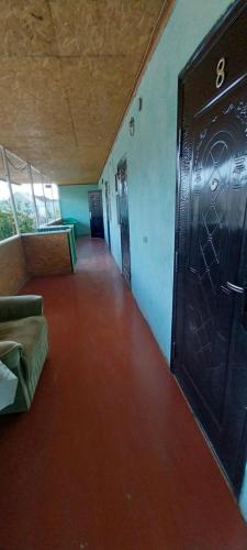 a hallway with a large door in a room at Керимкул Ата in Kaji-Say
